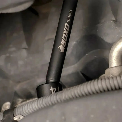 Close-up of a BoxoUSA 14mm universal impact extension socket engaged on a fastener beside a wiring loom