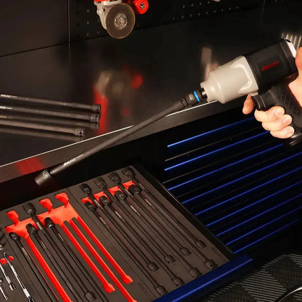 Technician fitting a BoxoUSA universal impact extension socket to a pneumatic impact wrench above an EVA foam drawer