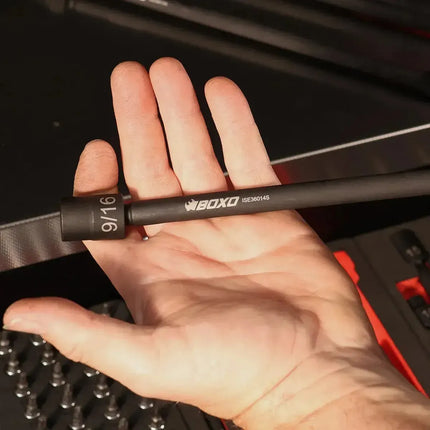 Hand holding a BoxoUSA 9/16 inch universal impact extension socket showing its length and black phosphate finish
