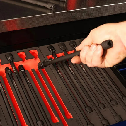 Technician lifting a universal impact extension socket from its EVA foam pocket, red base showing the empty slot