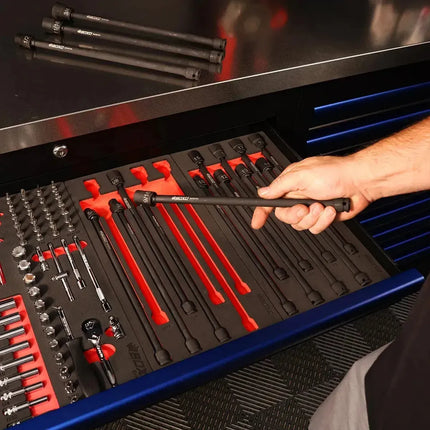Technician removing a universal impact extension socket from a BoxoUSA drawer alongside other EVA foam socket sets