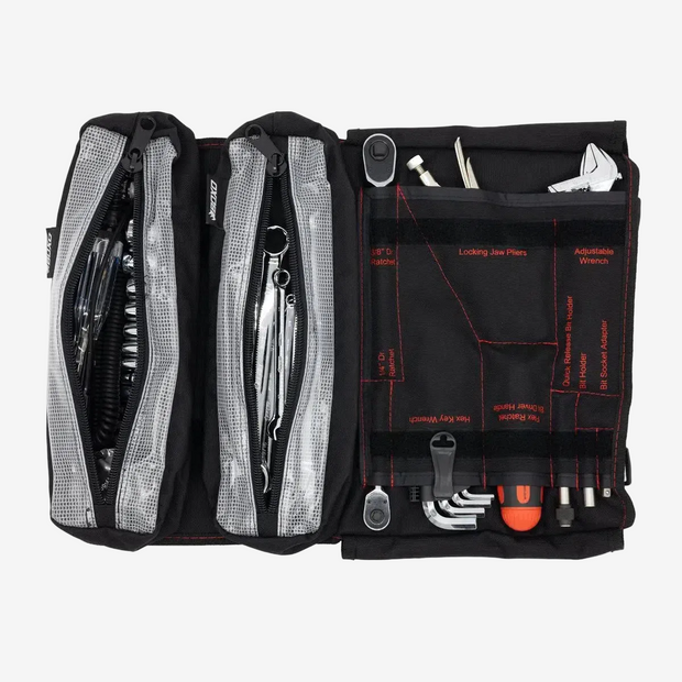 Open BoxoUSA 48-piece motorcycle tool roll showing organized SAE wrenches, sockets, and labeled pockets.
