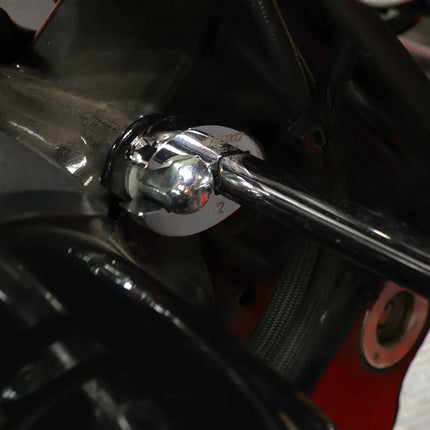 Crowfoot wrench reaching a fastener in a tight engine bay near hydraulic and fuel lines